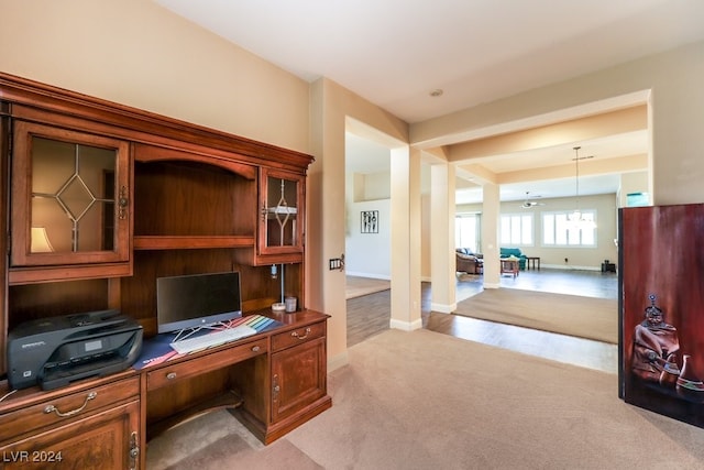 carpeted home office with ceiling fan