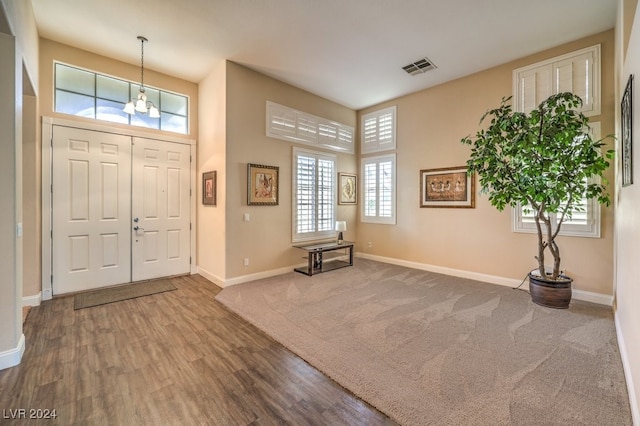 entryway with a chandelier, a high ceiling, and hardwood / wood-style flooring