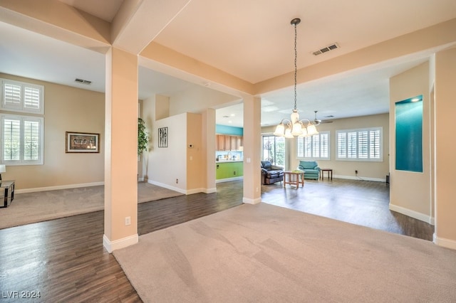 interior space with a notable chandelier and dark wood-type flooring