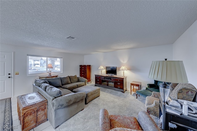 carpeted living room featuring a textured ceiling