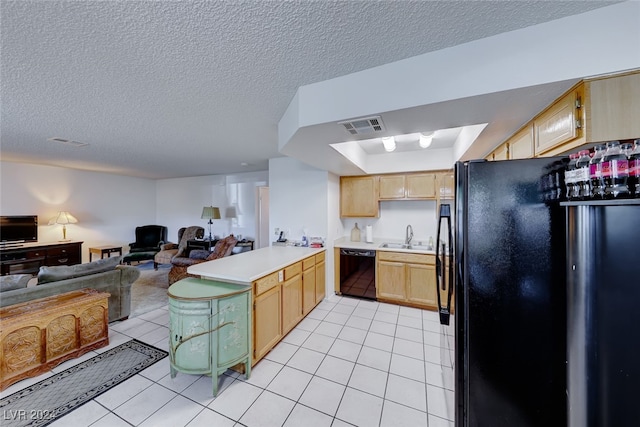 kitchen featuring black appliances, a textured ceiling, light tile patterned floors, light brown cabinetry, and sink