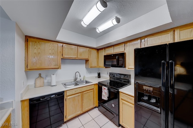 kitchen featuring black appliances, a textured ceiling, light tile patterned floors, light brown cabinetry, and sink