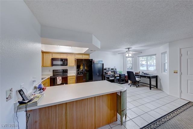 kitchen featuring light tile patterned flooring, black appliances, kitchen peninsula, ceiling fan, and a textured ceiling