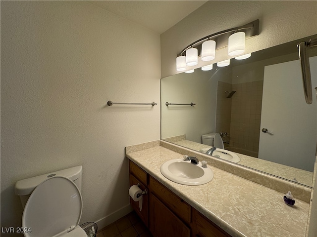 bathroom with vanity, tile patterned floors, and toilet