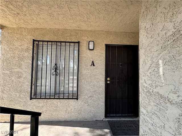 4464 W Desert Inn Rd Unit A, Las Vegas, NV 89102 - doorway to property featuring stucco siding