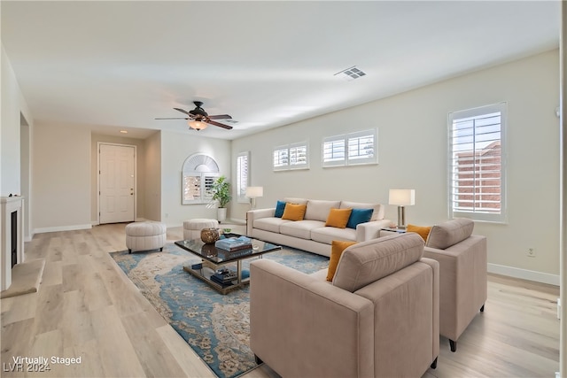 living room featuring light wood-type flooring and ceiling fan