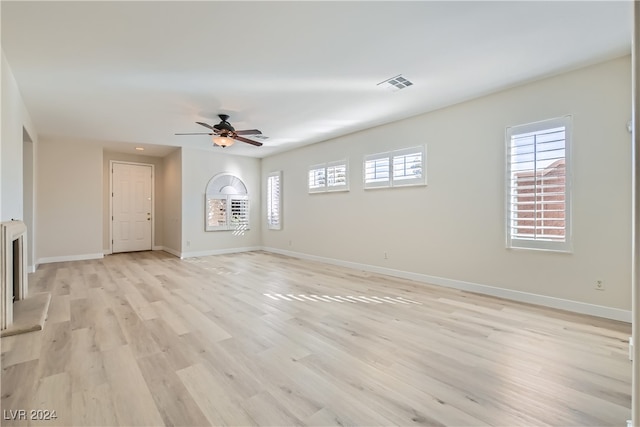 spare room with light wood-type flooring and ceiling fan