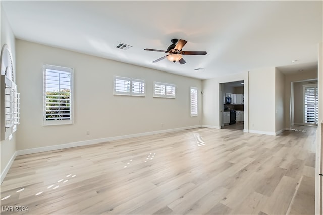 unfurnished living room with ceiling fan and light hardwood / wood-style flooring