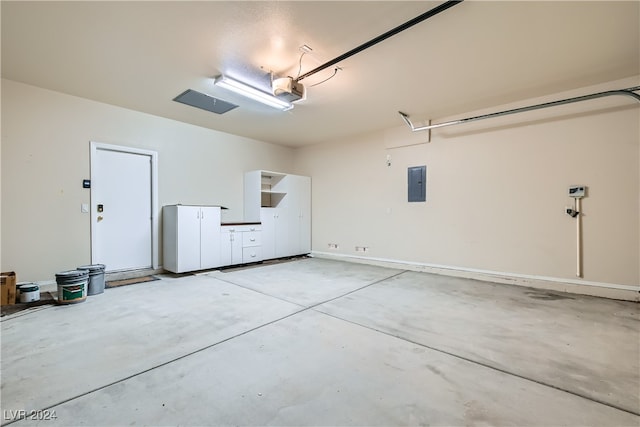 garage with electric panel and a garage door opener