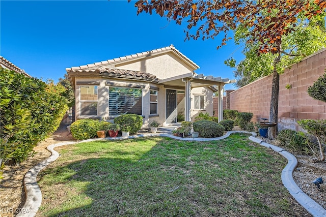 view of front of property with a pergola and a front yard