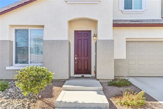 doorway to property with a garage