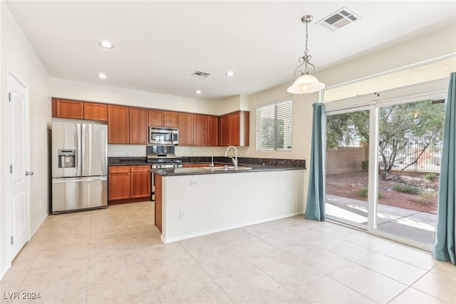 kitchen featuring sink, hanging light fixtures, and appliances with stainless steel finishes