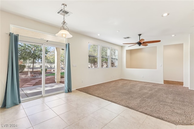 spare room featuring light tile patterned floors, plenty of natural light, and ceiling fan