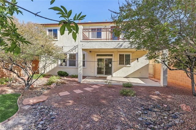 back of house with a patio area and a balcony