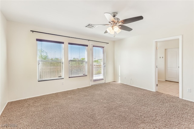 carpeted empty room featuring ceiling fan