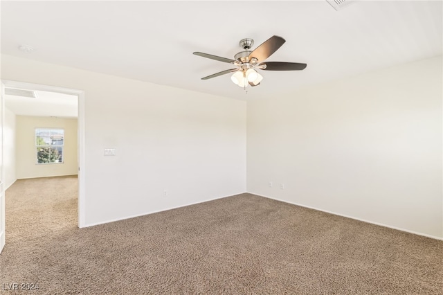 carpeted spare room with ceiling fan