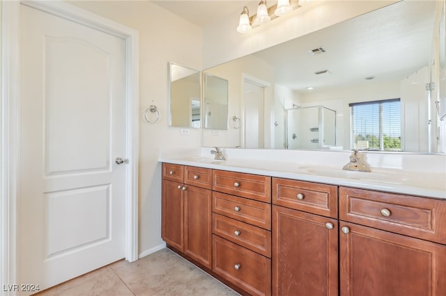 bathroom featuring tile patterned flooring, vanity, and walk in shower