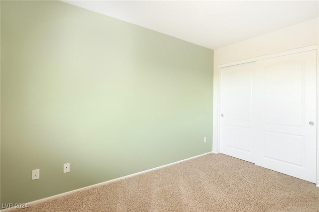 unfurnished bedroom featuring a closet and carpet