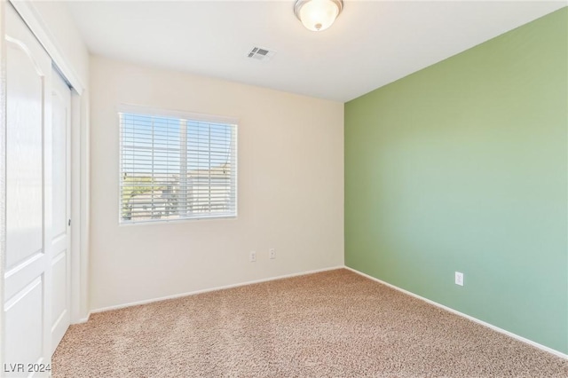 unfurnished bedroom with carpet floors and a closet