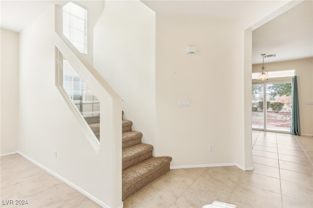 stairway with tile patterned floors