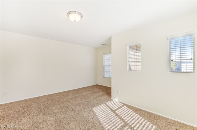 unfurnished room with light colored carpet