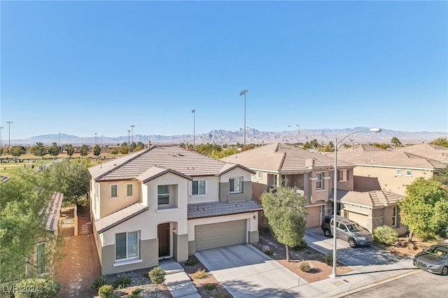 view of front of property with a mountain view and a garage