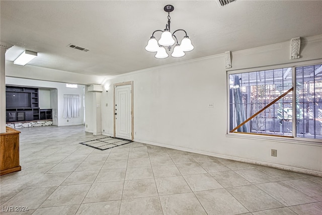 unfurnished dining area featuring a textured ceiling, a notable chandelier, light tile patterned flooring, and crown molding