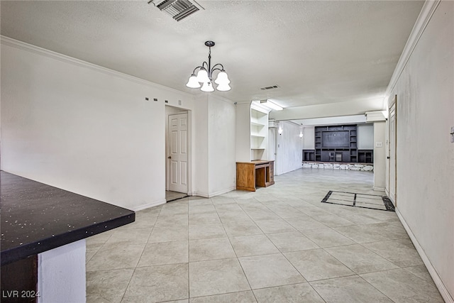 interior space with a textured ceiling, an inviting chandelier, light tile patterned floors, and crown molding