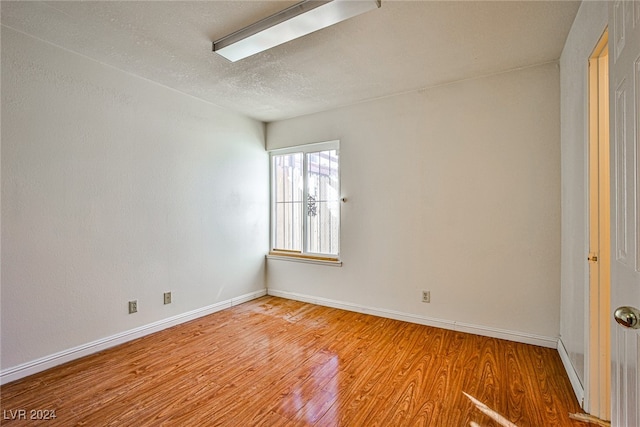 spare room featuring hardwood / wood-style floors