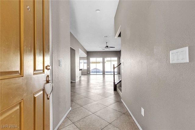 hall with light tile patterned floors