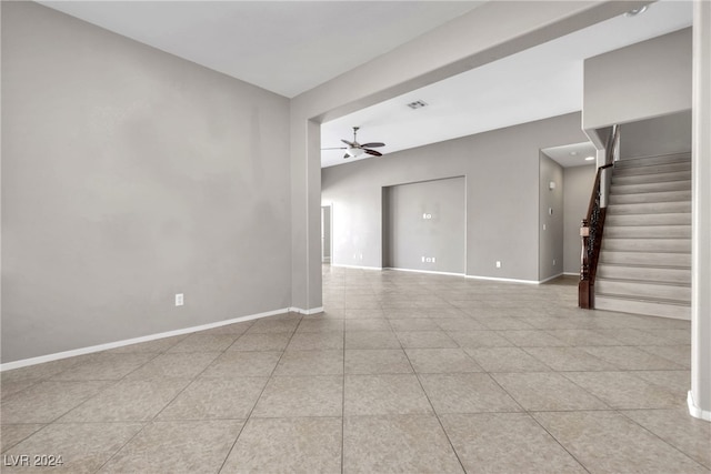 empty room featuring ceiling fan and light tile patterned floors