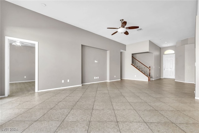 tiled spare room with ceiling fan