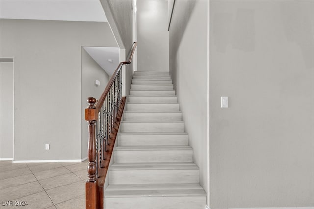 stairs with tile patterned flooring