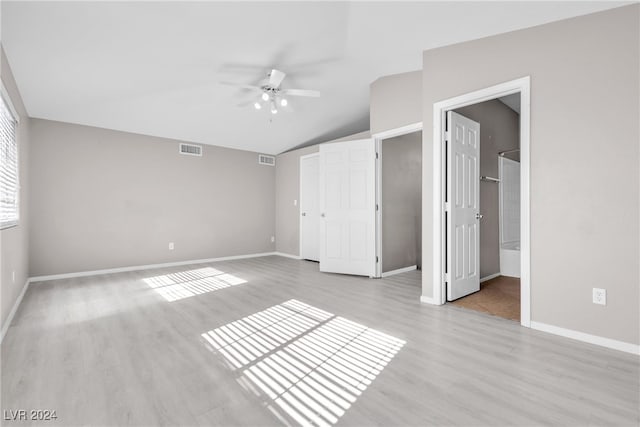 unfurnished bedroom with connected bathroom, a closet, light wood-type flooring, and ceiling fan