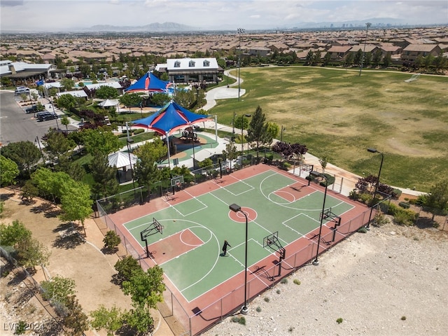 view of sport court featuring community basketball court, fence, and a residential view