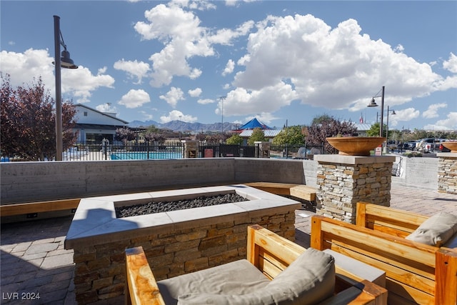 view of patio / terrace featuring a fire pit and a mountain view