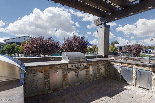 view of patio featuring an outdoor kitchen, a grill, and a pergola