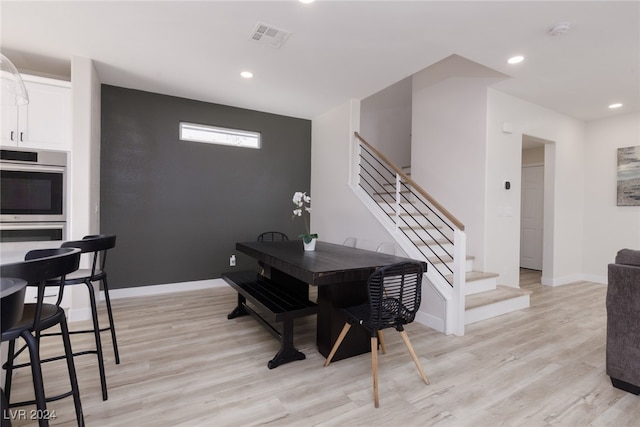 dining room featuring stairs, recessed lighting, light wood-type flooring, and baseboards