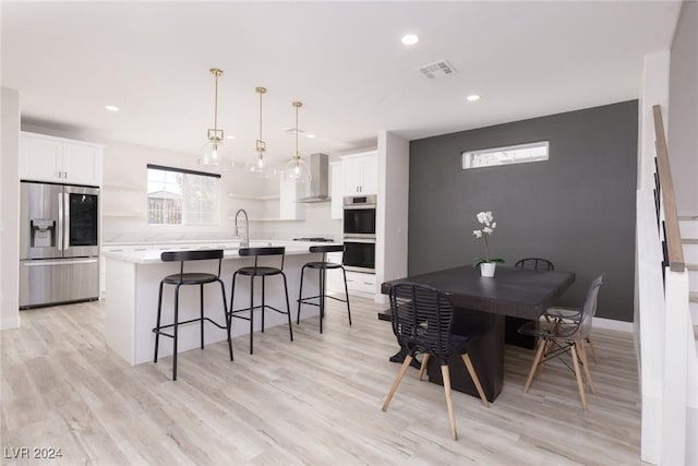 dining room featuring light wood-style flooring, visible vents, and recessed lighting