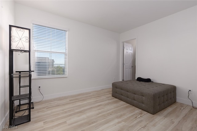 bedroom with baseboards and wood finished floors