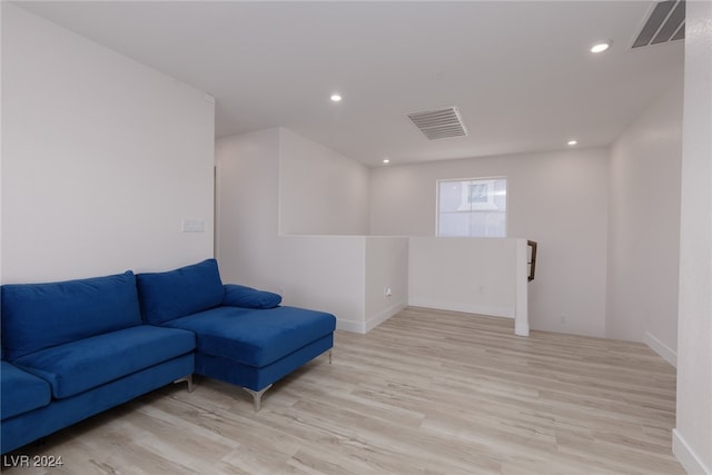 living room featuring light wood-style flooring, visible vents, and recessed lighting