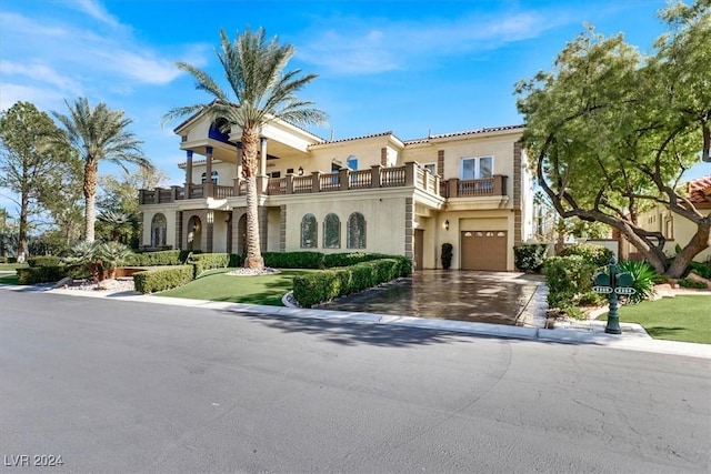 mediterranean / spanish-style home with a balcony and a garage