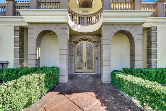 view of exterior entry featuring a balcony