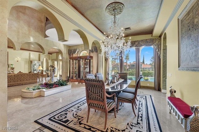 dining space featuring crown molding and a chandelier