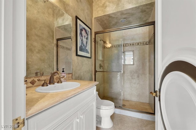 bathroom featuring tile patterned floors, toilet, an enclosed shower, and vanity