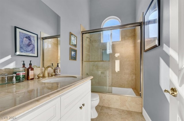 full bathroom with shower / bath combination with glass door, tile patterned flooring, vanity, and toilet