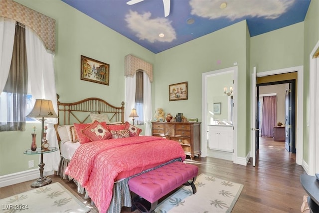 bedroom featuring connected bathroom, ceiling fan, dark hardwood / wood-style floors, and multiple windows