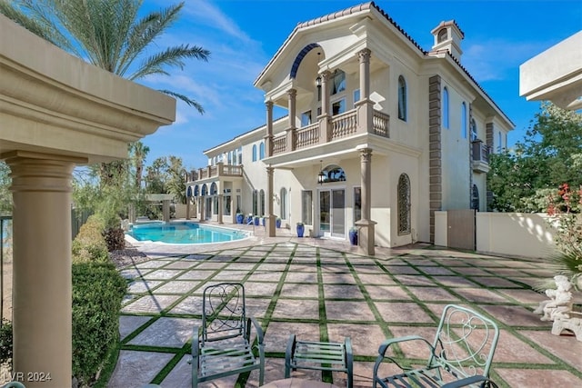 back of house featuring a balcony and a patio