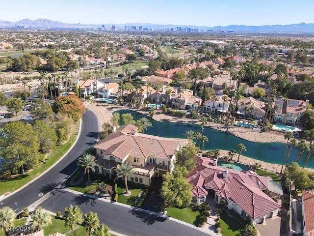 drone / aerial view featuring a water and mountain view