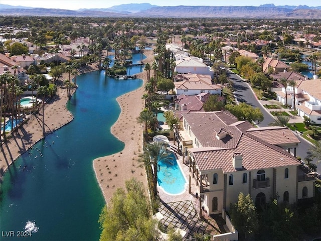 birds eye view of property featuring a water and mountain view